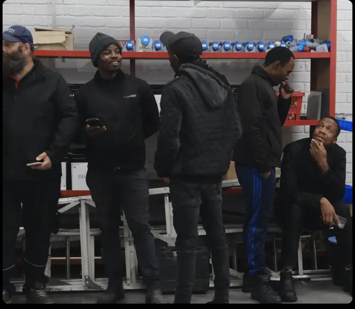 A team of electricians from Ampsure Electrical gathered in their workshop